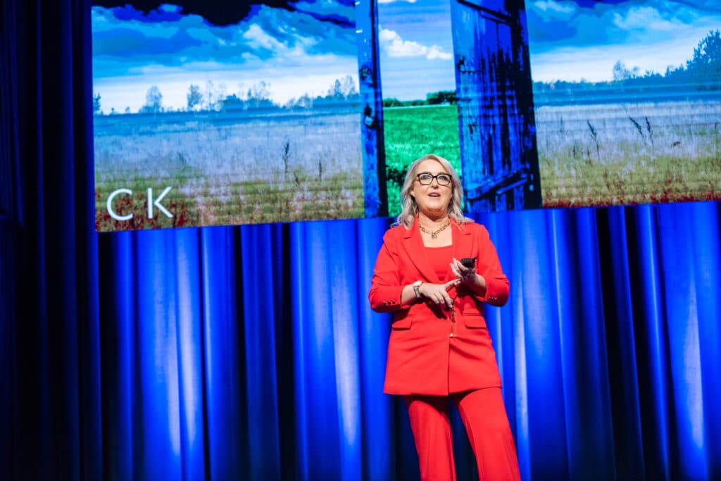 Caroline Kennedy speaking on stage about AI, business performance and transformation