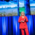 Caroline Kennedy speaking on stage about AI, business performance and transformation
